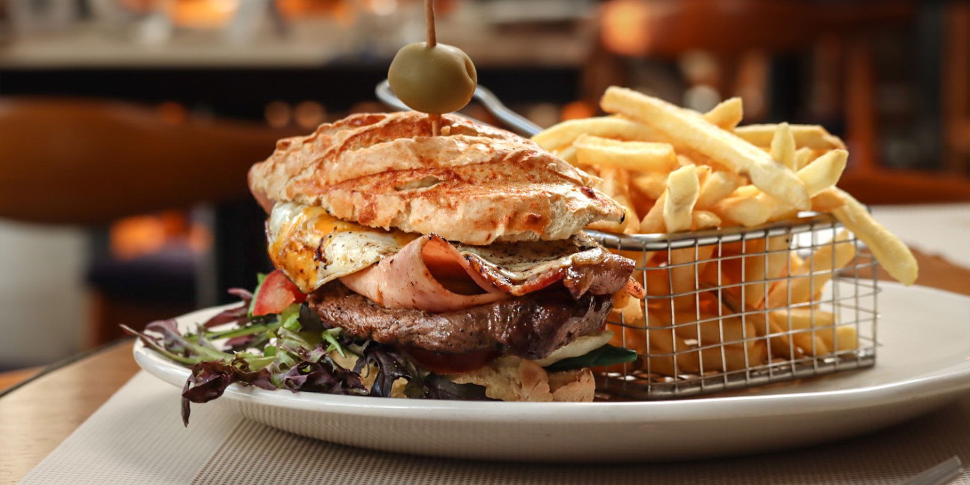 Clásico chivito al pan con papas fritas, en el Restaurant Rambla, Cottage Carrasco Hotel & Suites frente a la rambla